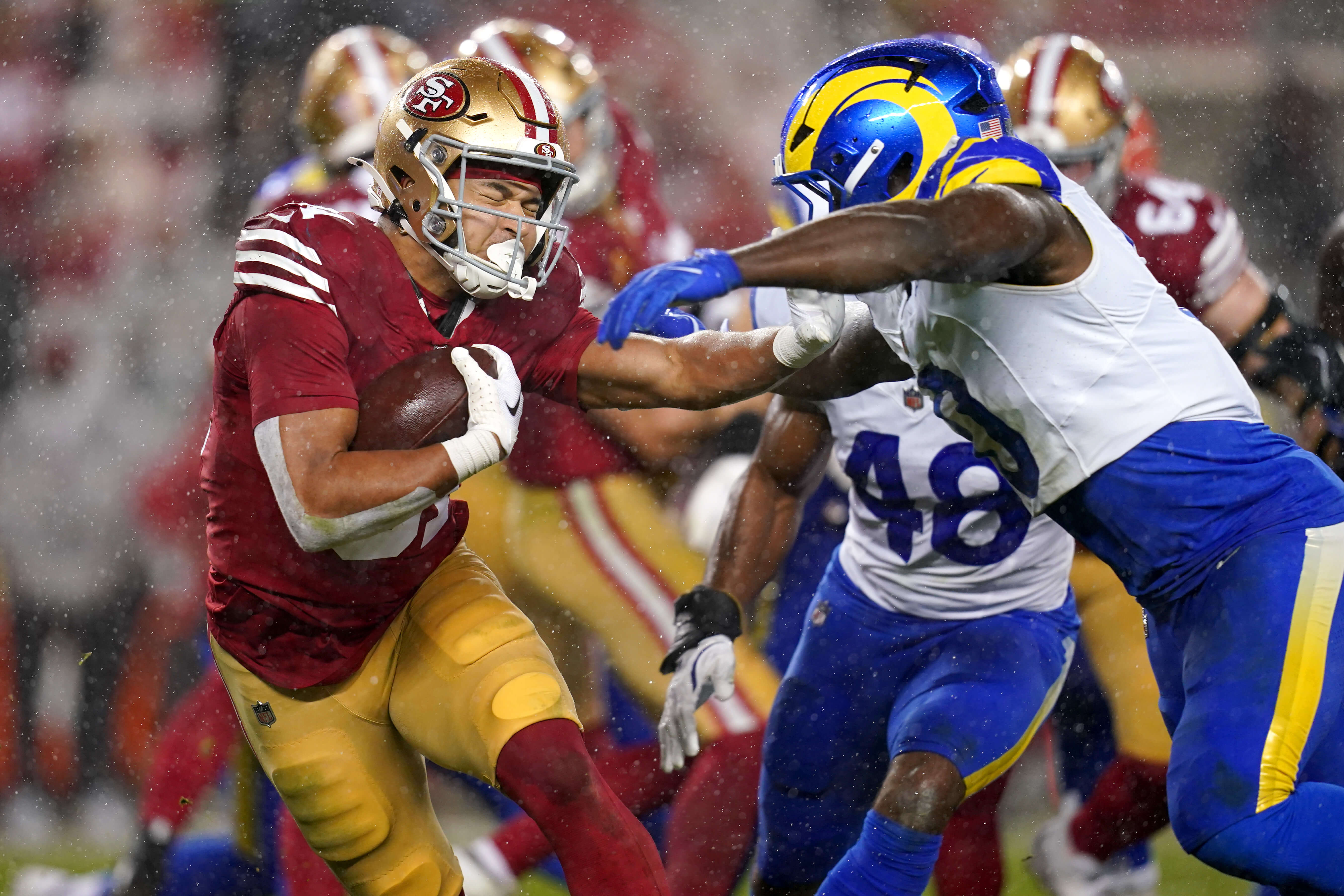 San Francisco 49ers running back Isaac Guerendo (31) runs the ball as Los Angeles Rams linebacker Byron Young (0) defends in the second quarter at Levi's Stadium. Mandatory Credit: Cary Edmondson-Imagn Images