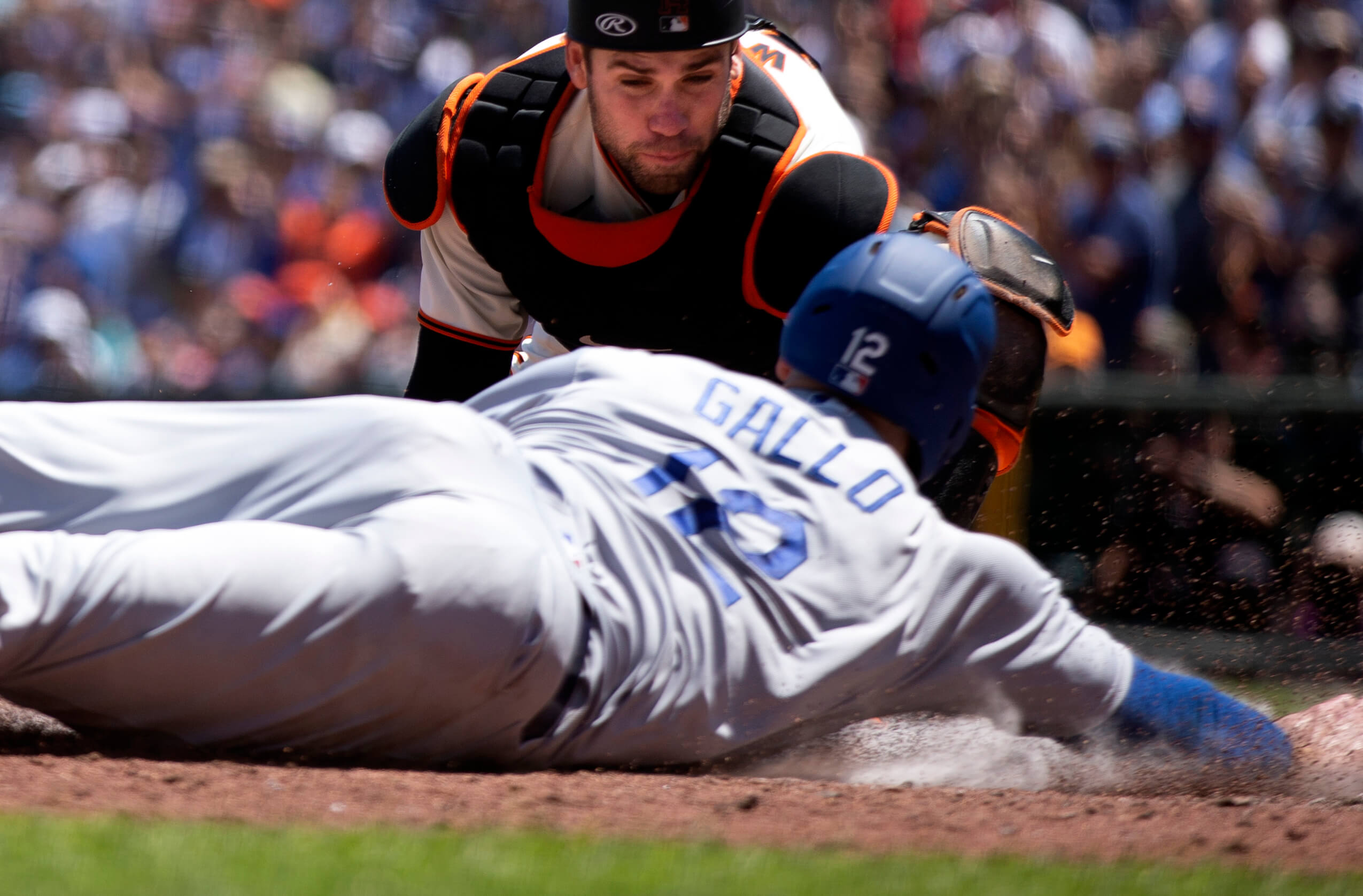 San Francisco Giants catcher Austin Wynns (14) prepares to put the tag on Los Angeles Dodgers left fielder Joey Gallo (12) as he tries to score on a double by Gavin Lux during the fourth inning at Oracle Park.