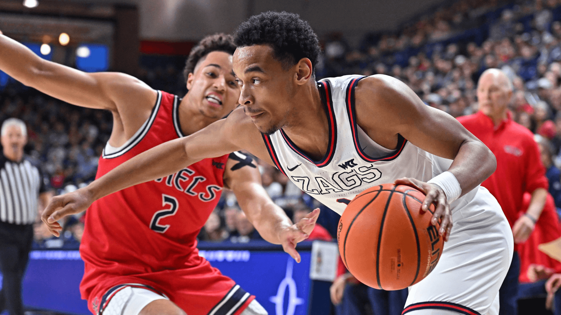 Gonzaga Bulldogs guard Nolan Hickman (11) runs the baseline against St. Mary's Gaels guard Jordan Ross (2).