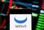In this photo illustration, the financial trading services company Webull logo seen displayed on a smartphone with an economic stock exchange index graph in the background. (Photo by Budrul Chukrut / SOPA Images/Sipa USA) 