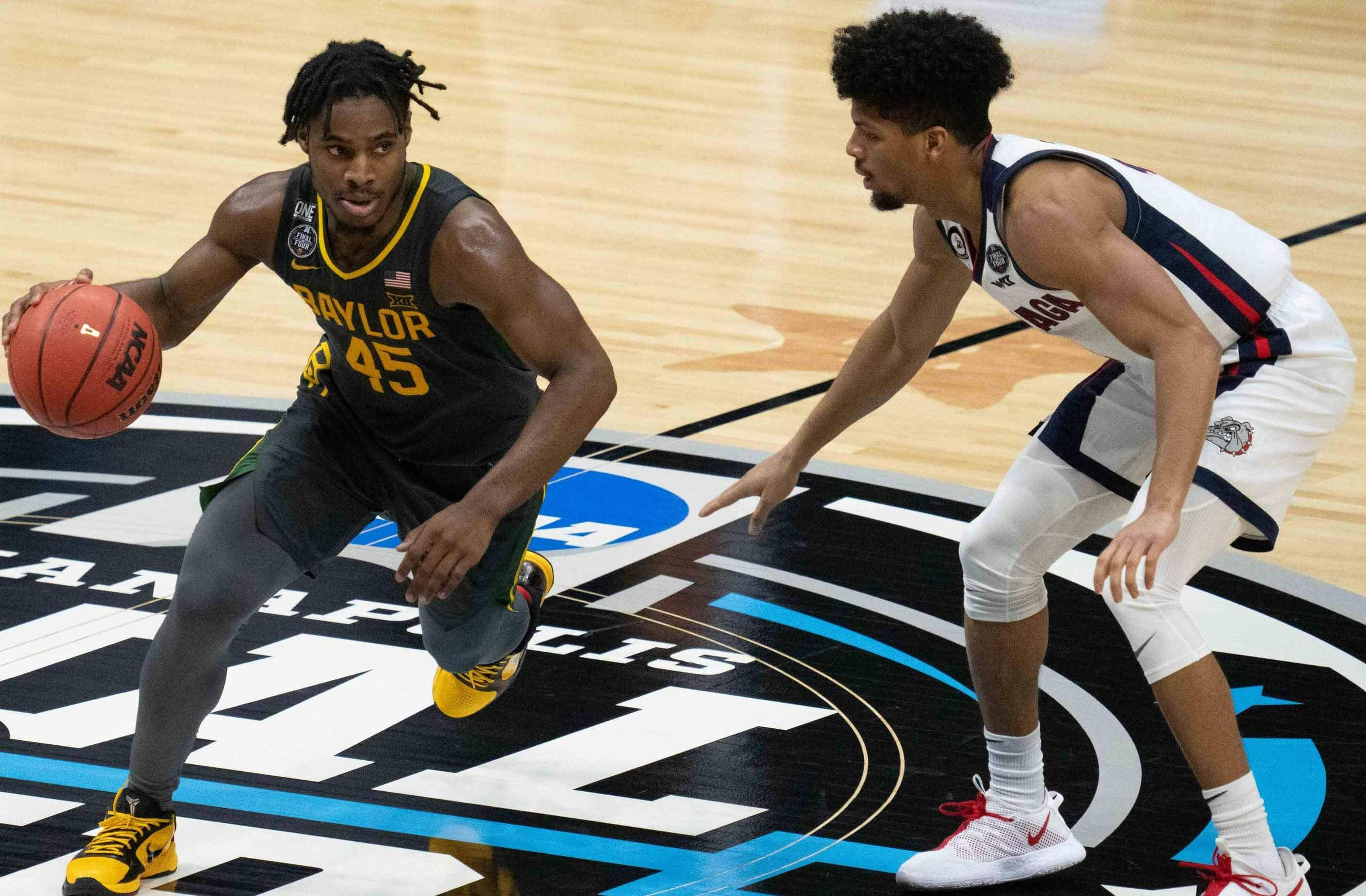 Baylor Bears guard Davion Mitchell (45) dribbles the basketball against Gonzaga Bulldogs guard Aaron Cook (4) in the second half during the national championship game in the Final Four of the 2021 NCAA Tournament at Lucas Oil Stadium.