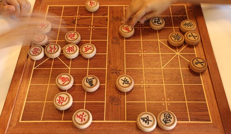 Overhead shot of players playing Chinese chess