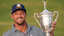 Bryson DeChambeau celebrates with the trophy after winning the U.S. Open golf tournament.