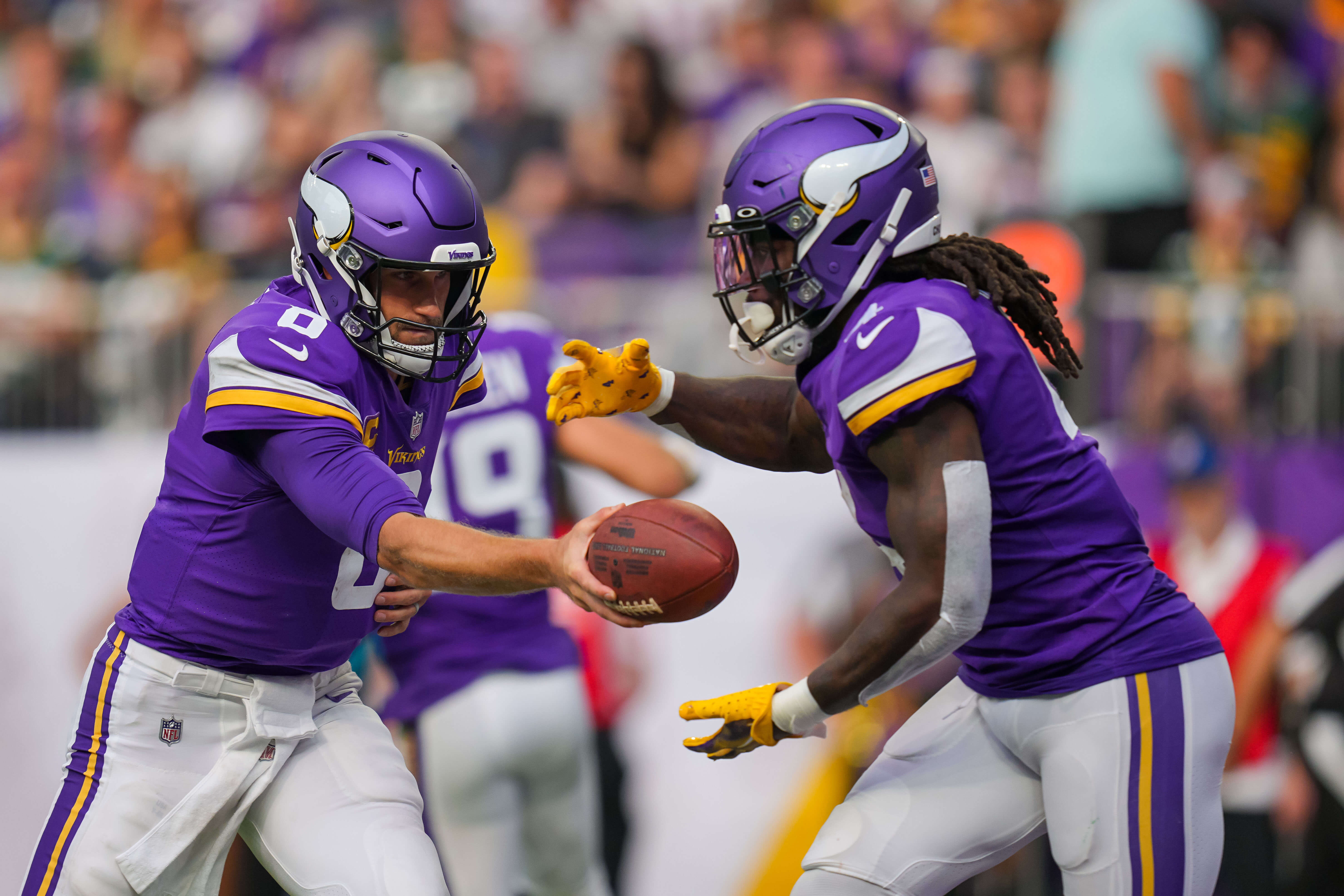 Sep 11, 2022; Minneapolis, Minnesota, USA; Minnesota Vikings quarterback Kirk Cousins (8) the hands the ball off to running back Dalvin Cook (4)