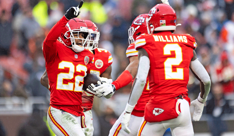 Trent McDuffie celebrates with teammates after an interception.