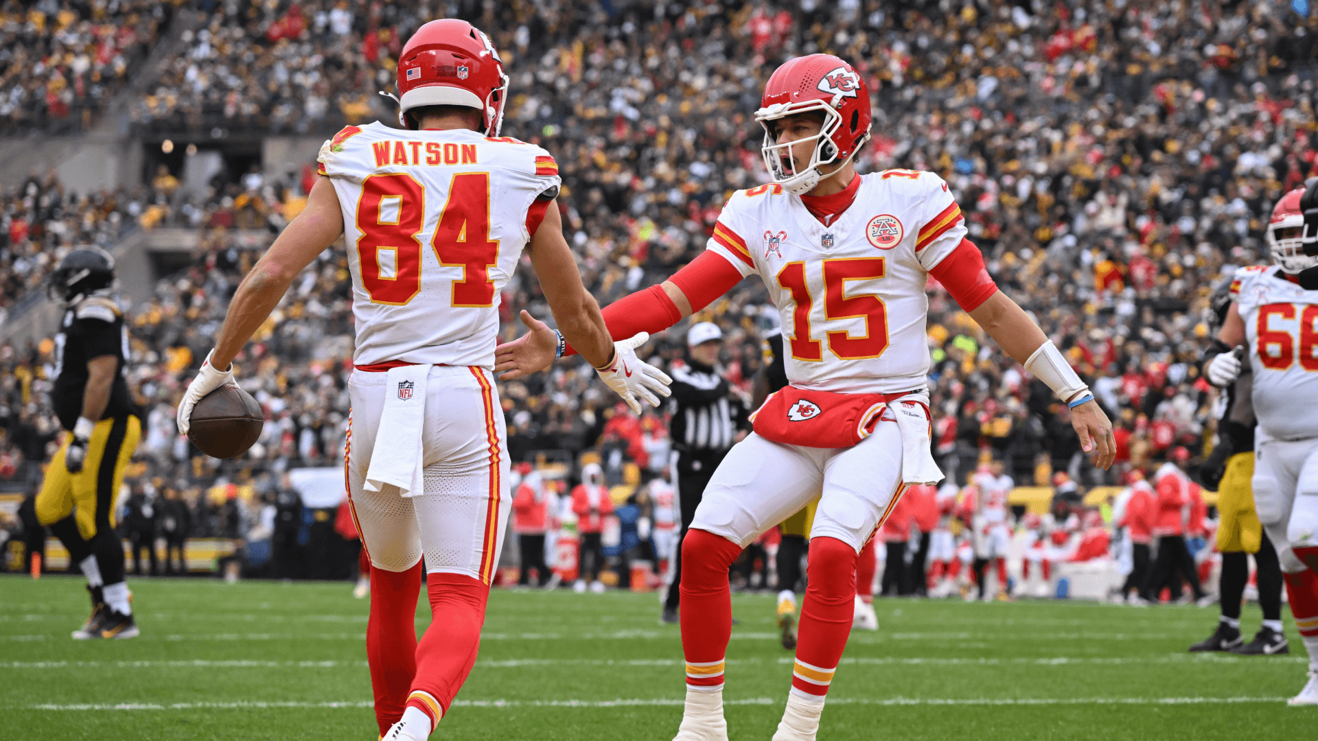 Kansas City Chiefs wide receiver Justin Watson (84) celebrates an 11-yard touchdown with quarterback Patrick Mahomes (15).