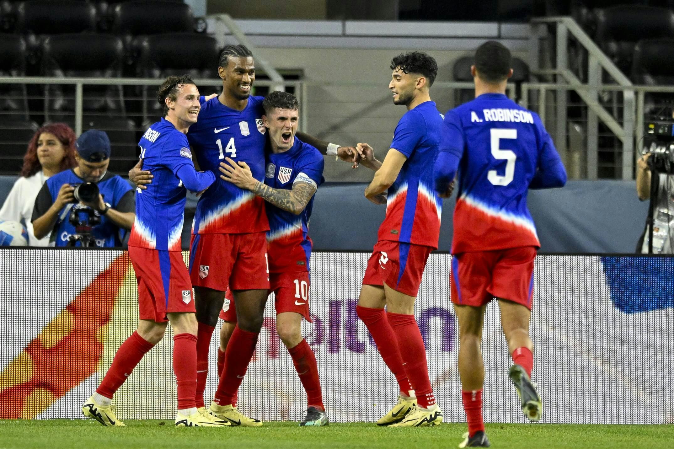 United States midfielder Haji Wright (14) and forward Josh Sargent (11) and United States forward Brenden Aaronson (11) and forward Christian Pulisic (10) and forward Ricardo Pepi (9) and defender Antonee Robinson (5) celebrate.