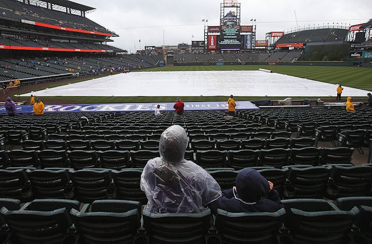 Rain causes a delay for MLB action at Coors Field.