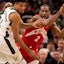 Raptors' Kawhi Leonard is guarded by Bucks' Giannis Antetokoumnpo.