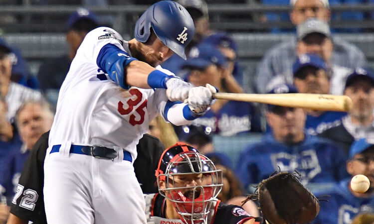 Los Angeles outfielder Cody Bellinger hits a ground ball in the National League playoffs.