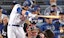 Los Angeles outfielder Cody Bellinger hits a ground ball in the National League playoffs.