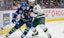 Minnesota's Joel Eriksson Ek checks Vancouver forward Bo Horvat in NHL action.