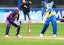 A batsman swings at the ball during a cricket match.