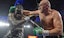 Tyson Fury throws a punch against Deontay Wilder in boxing action.