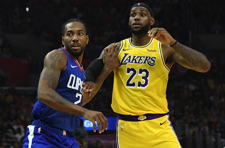 The Clippers Kawhi Leonard guards the Lakers LeBron James in NBA action.