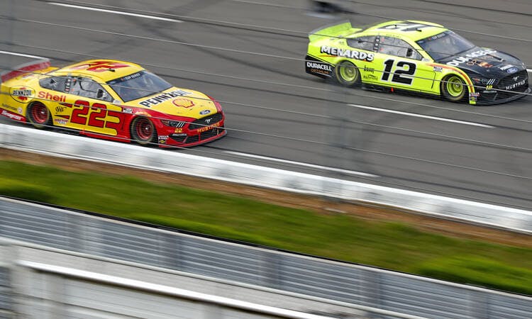 Joey Logano and Ryan Blaney race in NASCAR action.