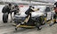 Pit crews race to change tires at Darlington Raceway.