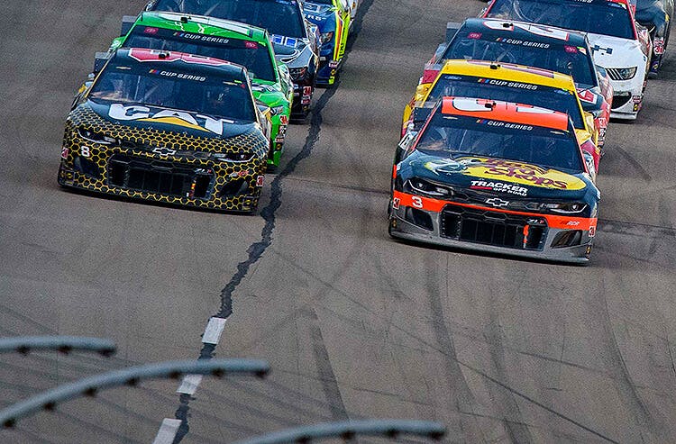NASCAR drivers line up early in a race.