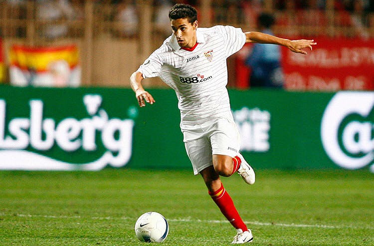 Sevilla captain Jesus Navas dribbles the ball in soccer action. 