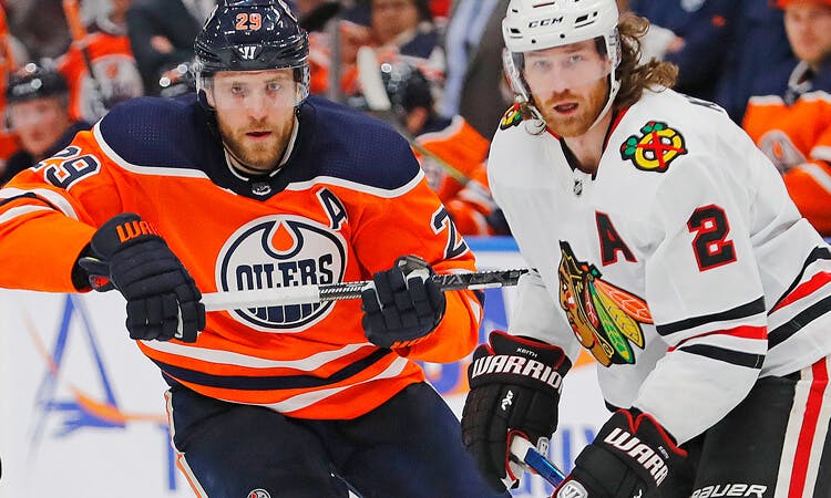 Edmonton's Leon Draisaitl and Chicago's Duncan Keith battle in NHL action.