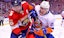 Florida's Aaron Ekblad and Michael Dal Colle of the Islanders battle for the puck in NHL action.