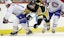 Montreal's Brendan Gallagher and Pittsburgh's Patric Hornqvist battle for the puck in NHL action.