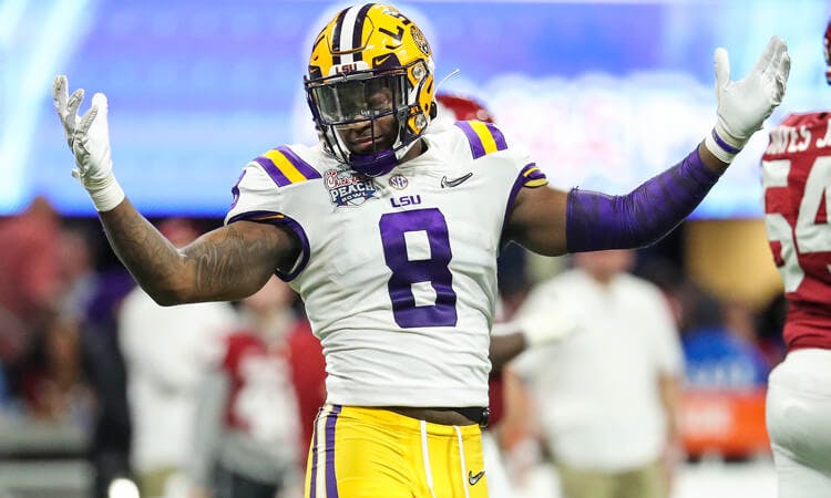 LSU player Patrick Queen celebrates in NCAA football action.