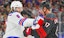 New York Rangers defenseman Jacob Trouba jostles Carolina Hurricanes forward Andrei Svechnikov in NHL action.