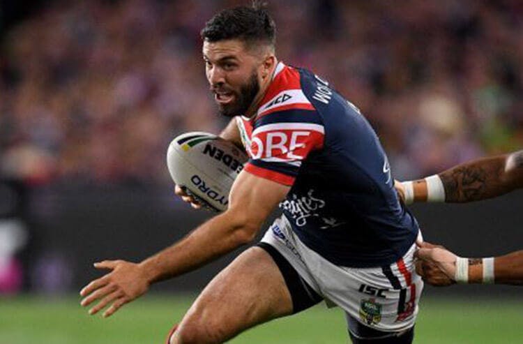 James Tedesco runs the ball in rugby league action. 