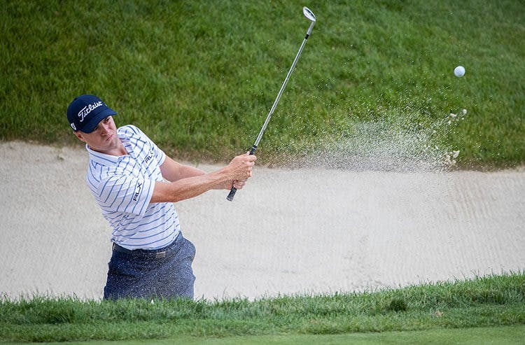 PGA Tour golfer Justin Thomas blasts out of the sand.